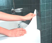 Remove paper liner from adhesive. Place in position on penciled marks carefully making contact with wall and top of tub at same time.