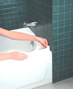 Remove bottom section from guard and expose adhesive. Carefully place against wall and top of tub inside pencil outline.